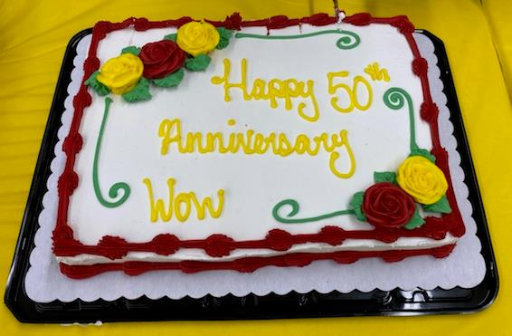 Birthday cake that reads "Happy 50th Anniversary WOW"